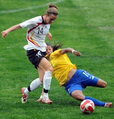 Photo: Cristiane of Brazil fights for the ball